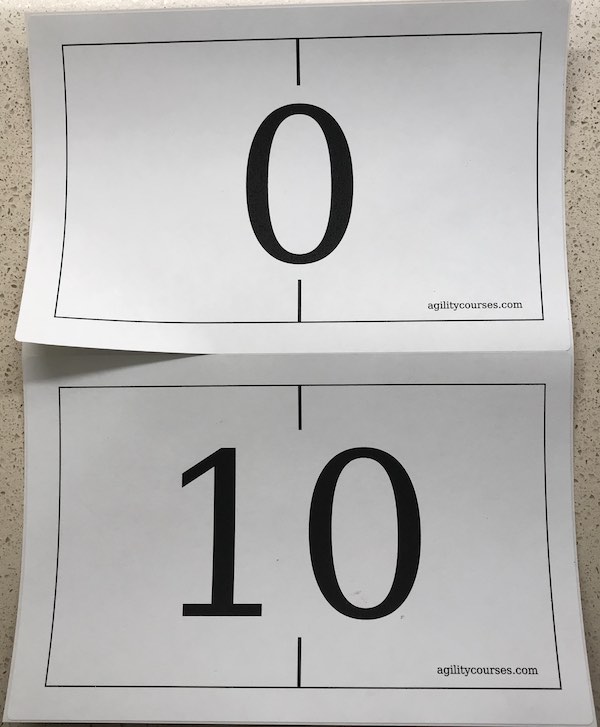 Image of two wall numbers showing one half page sticker being peeled up